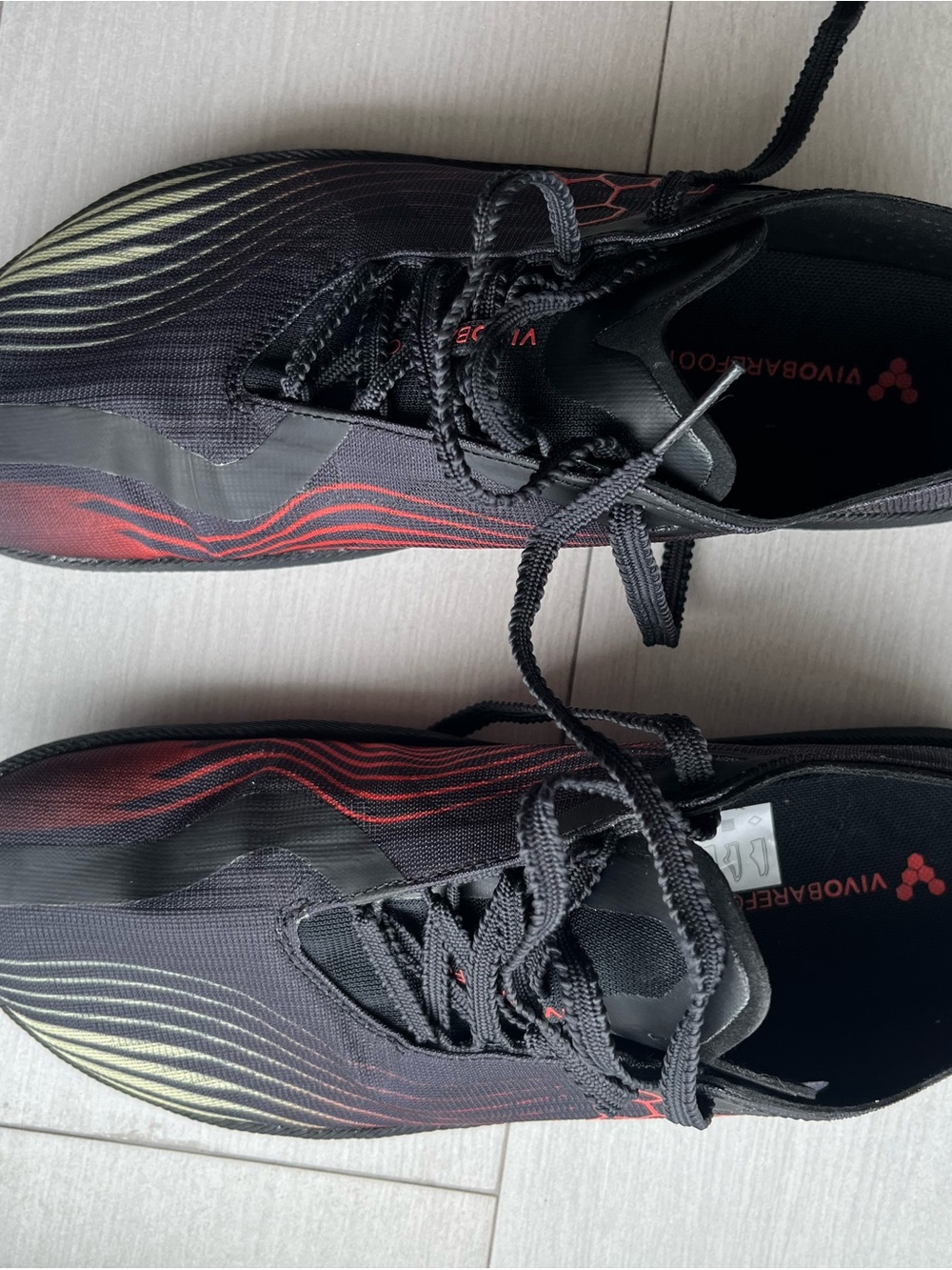 Vivo Barefoot Black Athletic Shoes with Red and Yellow Wave Accents